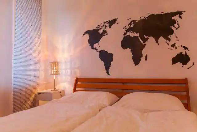 Guļamistaba ar pasaules kartes uzlīmi pie sienas